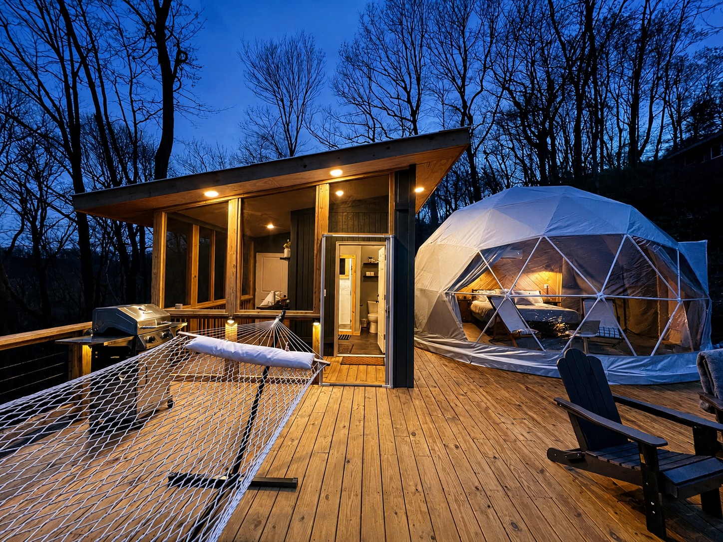 Custom elevated deck with geodesic dome and lit cabin at blue hour, built in the High Country