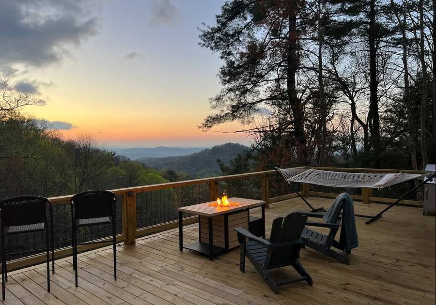 Custom mountain deck with fire table and hammock overlooking Blue Ridge ridgelines at sunset