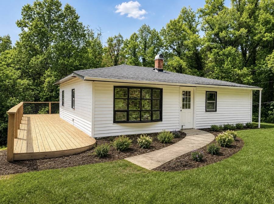 Completed new construction home with curved deck and landscaping by BluWolf Contracting